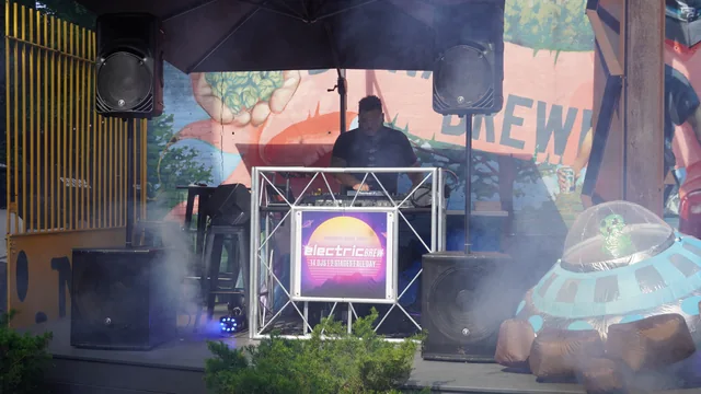 The outdoor Electric Brew stage with a UFO decoration and drifting stage fog
